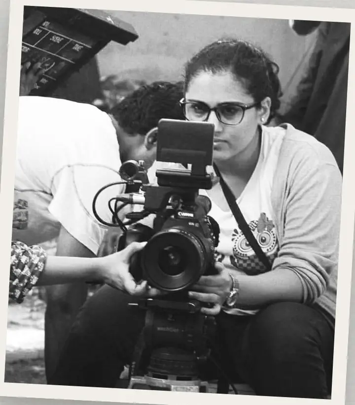 Cinematographer behind a cinema camera, black and white