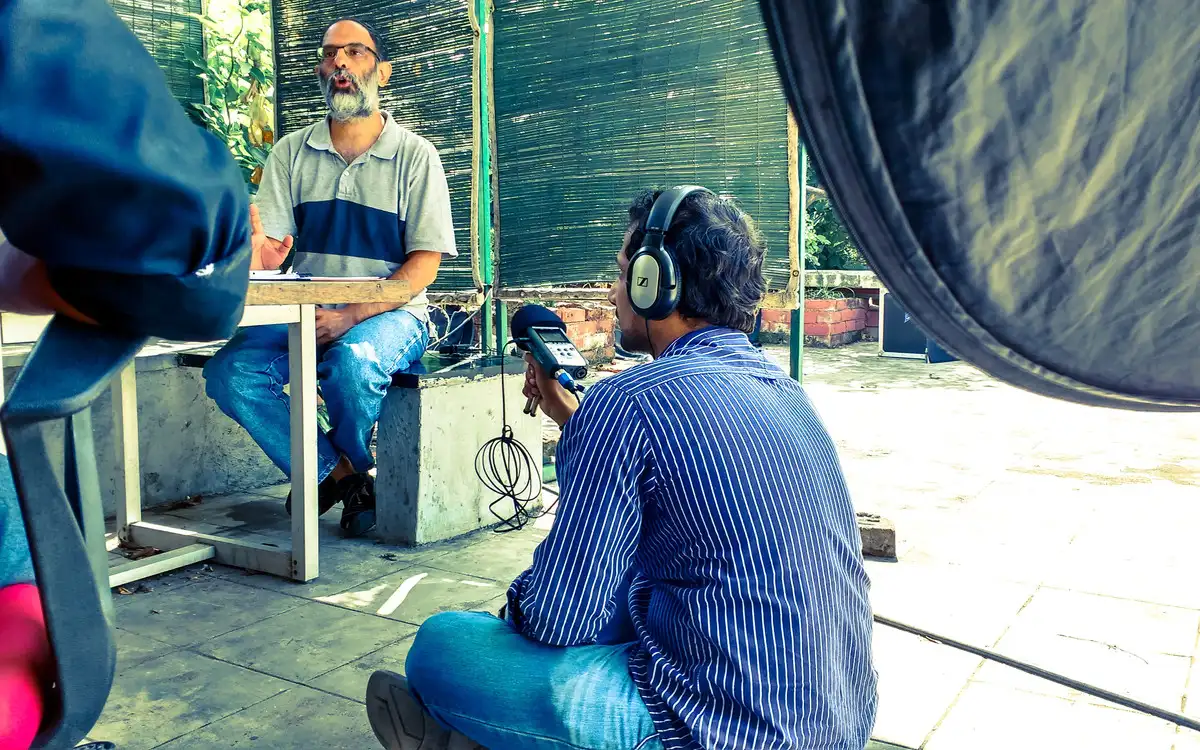 Sound recordist with headphones during a seated interview