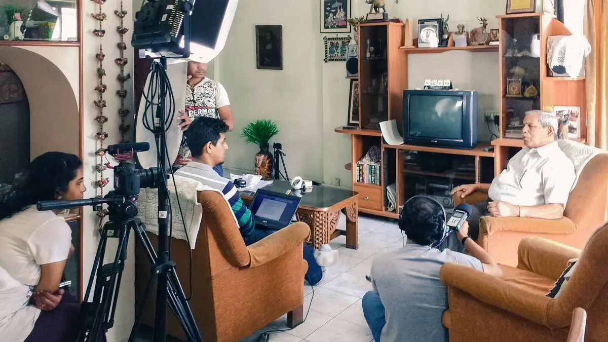 Crew filming in a living room